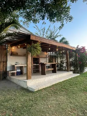 a wooden pavilion with a table in a yard at Ikako beach club in Cartagena de Indias