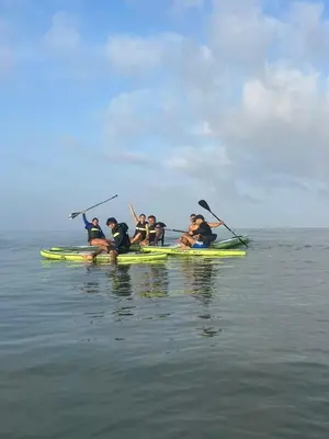 a group of people in a kayak on the water at Ikako beach club in Cartagena de Indias