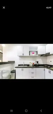 a kitchen with white cabinets and a counter top at Marinares apartamento in Cartagena de Indias