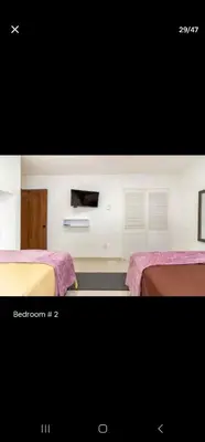 a bedroom with two beds with pink blankets at Marinares apartamento in Cartagena de Indias