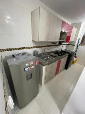 a small kitchen with a sink and a refrigerator at Brisas del caribe in Cartagena de Indias