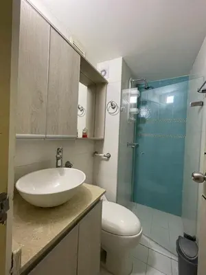 a bathroom with a sink and a toilet and a glass shower at Brisas del caribe in Cartagena de Indias