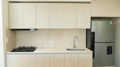 a kitchen with a sink and a refrigerator at New & Comfortable Apartment 2 BR In Cielo Mar in Cartagena de Indias
