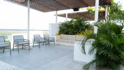 a group of chairs sitting on a patio at New & Comfortable Apartment 2 BR In Cielo Mar in Cartagena de Indias