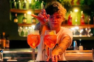 a woman is holding two glasses of wine at Viajero Cartagena - Getsemaní Hostel in Cartagena de Indias