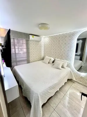 a bedroom with a white bed in a room at Luxury loft with pool in Barranquilla