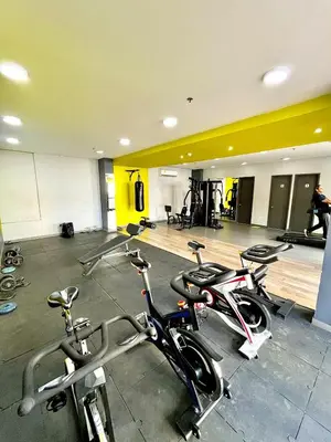 a gym with three bikes parked in a room at Luxury loft with pool in Barranquilla