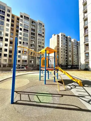 an empty playground in a city with tall buildings at Luxury loft with pool in Barranquilla