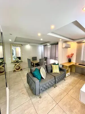 a living room with a couch and a table at Luxury loft with pool in Barranquilla