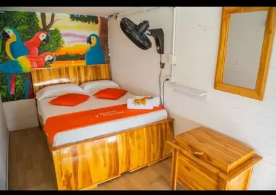a bedroom with a wooden bed in a room at TESORO de BARU in Cartagena de Indias