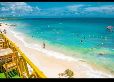 a group of people in the water at a beach at TESORO de BARU in Cartagena de Indias