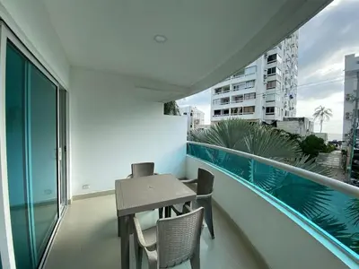 a balcony with a table and chairs on a building at Laguito Apartment in Cartagena de Indias