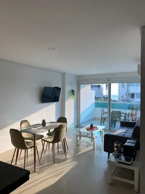 a living room with a table and chairs and a couch at Laguito Apartment in Cartagena de Indias