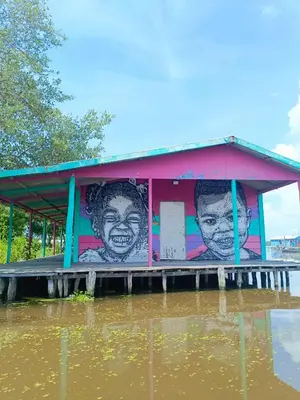 a building with a painting on it in the water at Laguna tour in Nueva Venecia