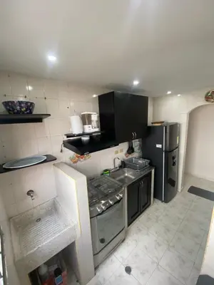 a kitchen with a stove and a refrigerator at Encanto Barranquillero! in Barranquilla