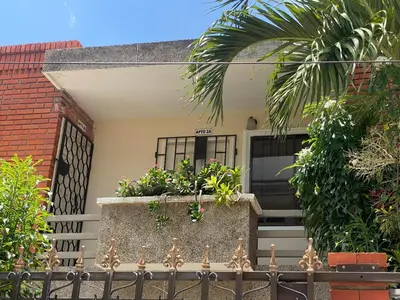 a house with a window box with flowers on it at Encanto Barranquillero! in Barranquilla