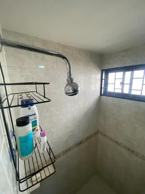 a bathroom with a shower with a light on the wall at Encanto Barranquillero! in Barranquilla