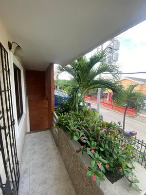 a balcony with a bunch of plants and a building at Encanto Barranquillero! in Barranquilla