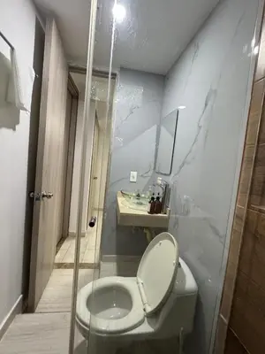 a bathroom with a toilet and a sink at Apartamentos Crespo 67 aeropuerto in Cartagena de Indias