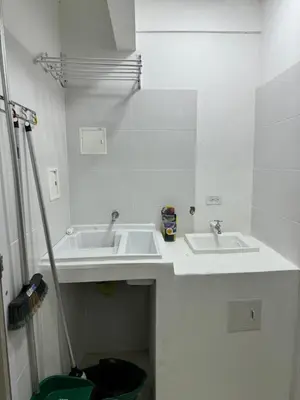 a white bathroom with two sinks in a room at Apartamentos Crespo 67 aeropuerto in Cartagena de Indias