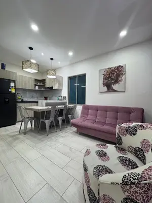 a living room with a purple couch and a table at Apartamentos Crespo 67 aeropuerto in Cartagena de Indias