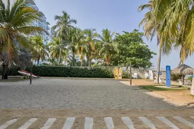 a park with palm trees and a playground at Hermoso Apartamento Frente al Mar 2 Habitaciones PAZ146 in Coveñitas
