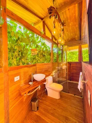 a bathroom with a toilet and a sink at COCO SALVAJE Tree House in La Rada