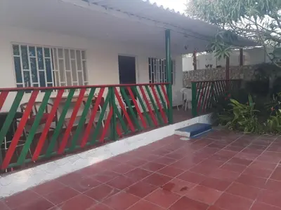 a red fence in front of a house at Cabaña Puerto Colombia CARNAVAL BARRANQUILLA 2025 in Puerto Colombia