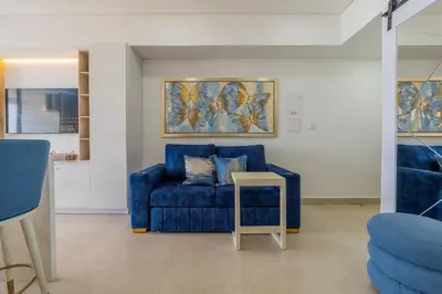a blue couch in a living room with a table at CB910 | Suite frente al mar diseño moderno balcon in Cartagena de Indias