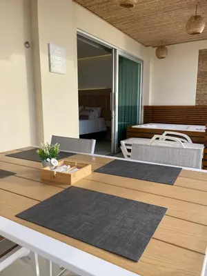 a room with a table and chairs and a bedroom at Un paraíso frente al mar in San Silvestre