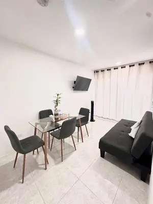 a living room with a couch and a table and chairs at Cozy Beachside 3BR Apartment near the Walled City in Cartagena de Indias