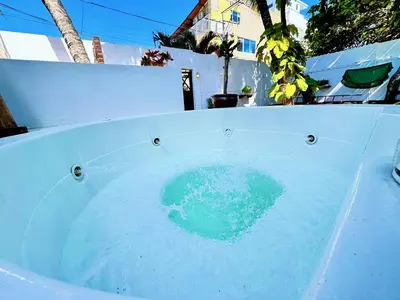 a bath tub filled with blue water next to a fence at Auaecoco Hotel in Cartagena de Indias