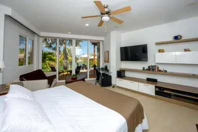 a bedroom with a large bed and a flat screen tv at Maravillosa Villa en Marina Baru enCartagena! in Isla Barú