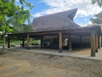 a pavilion with a thatched roof on a patio at Maravillosa Villa en Marina Baru enCartagena! in Isla Barú