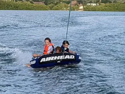 two children are riding in a boat on the water at Maravillosa Villa en Marina Baru enCartagena! in Isla Barú