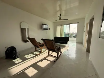 a living room with two chairs and a couch at Apartments Tolú 3 habitaciones in Tolú