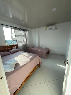 a bedroom with a large bed and a window at Apartments Tolú 3 habitaciones in Tolú