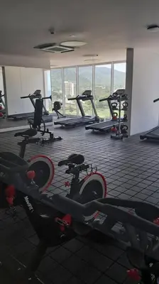 a gym with a bunch of exercise bikes in a room at Aparta suite cerca al mar por vía Irotama in Santa Marta