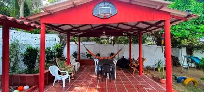 a red gazebo with chairs and a grill at Casa campestre Magyli in Puerto Salgar