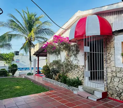 a building with a red and white umbrella on it at Casa campestre Magyli in Puerto Salgar