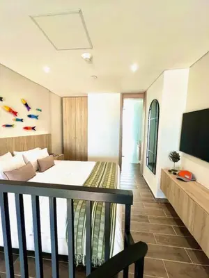 a bedroom with a bed and a television in it at THE LOFT 405 in San Basilio - La Matuna - Cartagena in Cartagena de Indias