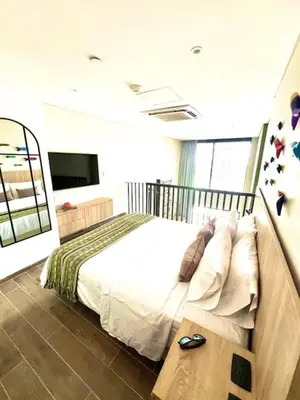 a bedroom with a bed and a flat screen tv at THE LOFT 405 in San Basilio - La Matuna - Cartagena in Cartagena de Indias