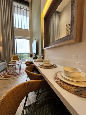 a dining room with a table with plates and chairs at THE LOFT 405 in San Basilio - La Matuna - Cartagena in Cartagena de Indias