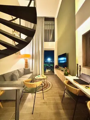 a living room with a couch and a table with a laptop at THE LOFT 405 in San Basilio - La Matuna - Cartagena in Cartagena de Indias