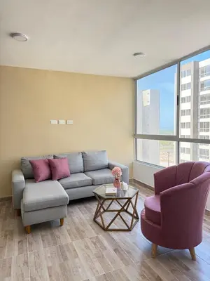 a living room with a couch and two chairs at Margarita's apartment in Puerto Colombia