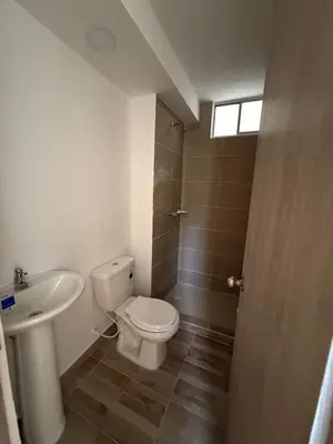 a bathroom with a toilet and a sink at Margarita's apartment in Puerto Colombia