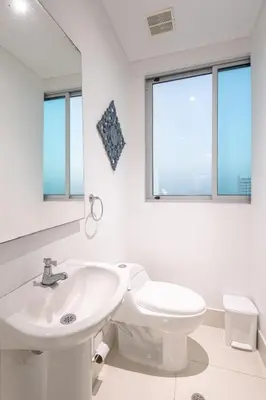 a white bathroom with a sink and a toilet at Majestic apt with an ocean view Palmetto Beach in Cartagena de Indias