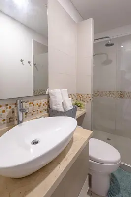 a bathroom with a white sink and a toilet at Majestic apt with an ocean view Palmetto Beach in Cartagena de Indias