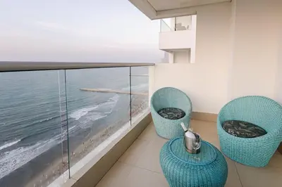 a balcony with two chairs and a view of the ocean at Majestic apt with an ocean view Palmetto Beach in Cartagena de Indias