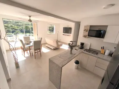 a kitchen and living room with a table and chairs at Tu refugio perfecto in Manzanillo del Mar